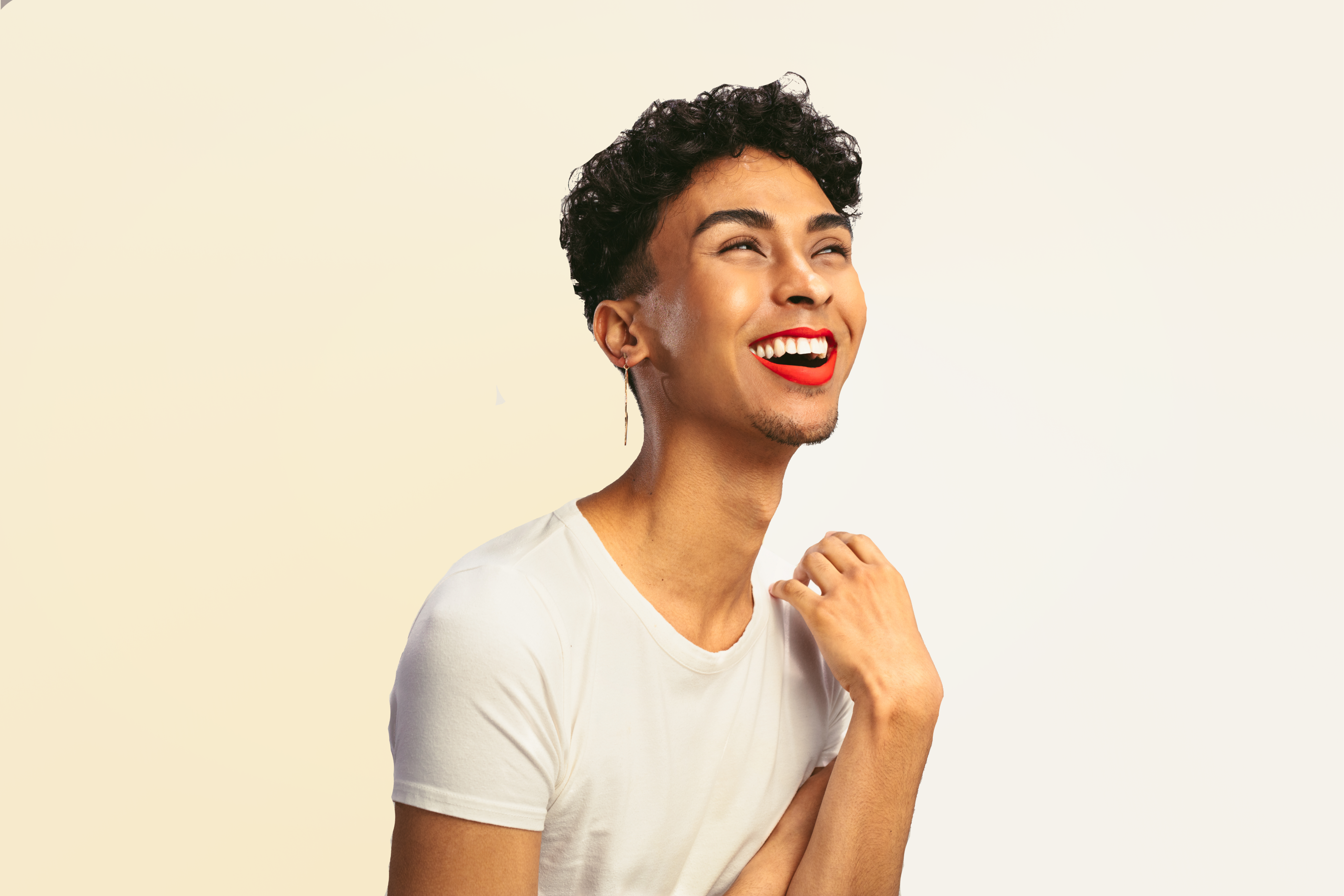 A young man smiling in a white teeshirt